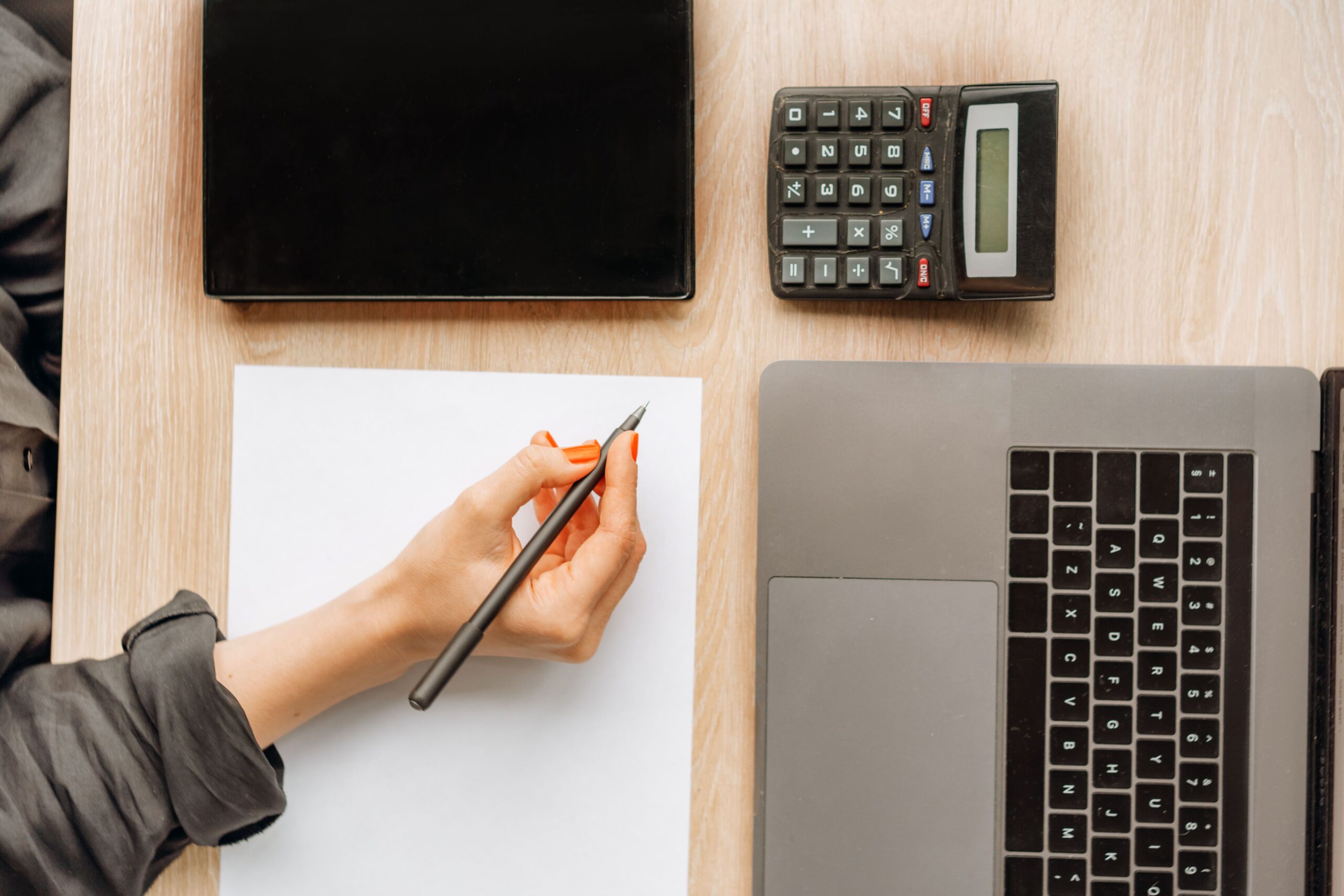 Side hustle worth it math check: calculator and laptop on a desk