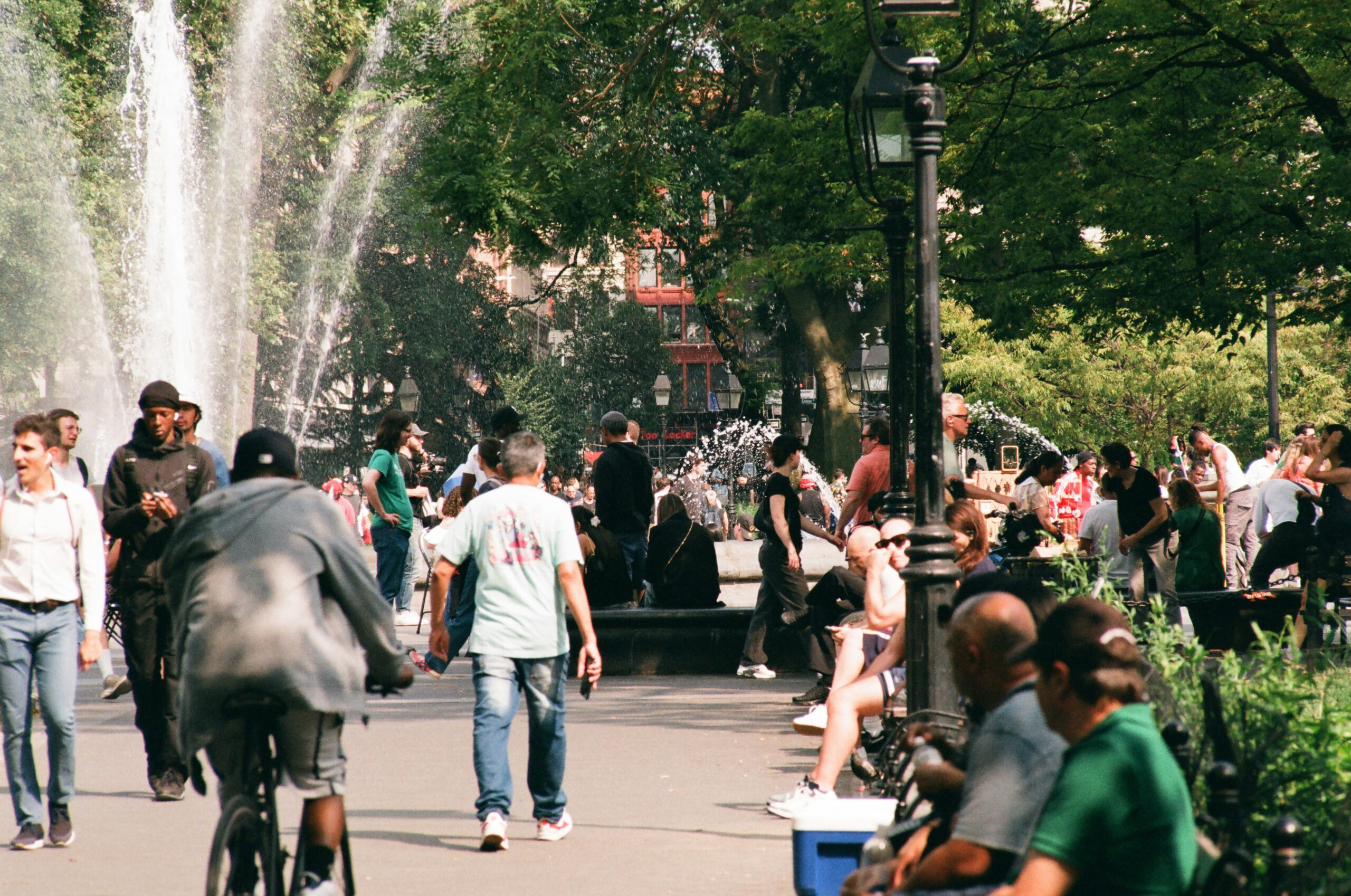 Canada tariffs job losses: people enjoying an ordinary sunny afternoon at a park fountain, the routine that could change fast